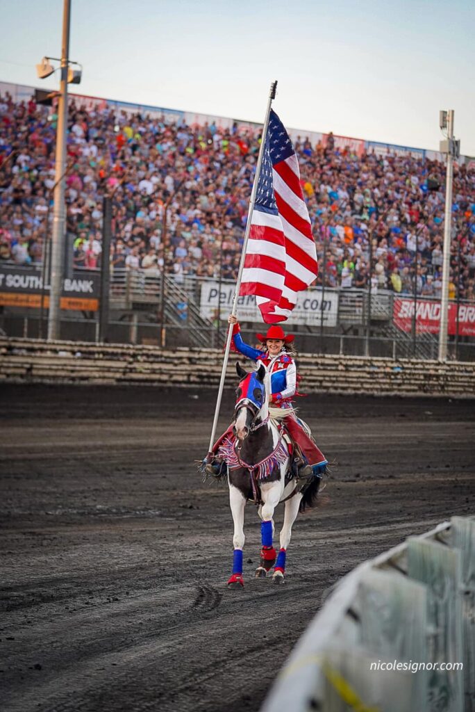 Jacee Ball and her horse present the Nations colors, in a show-stopping performance